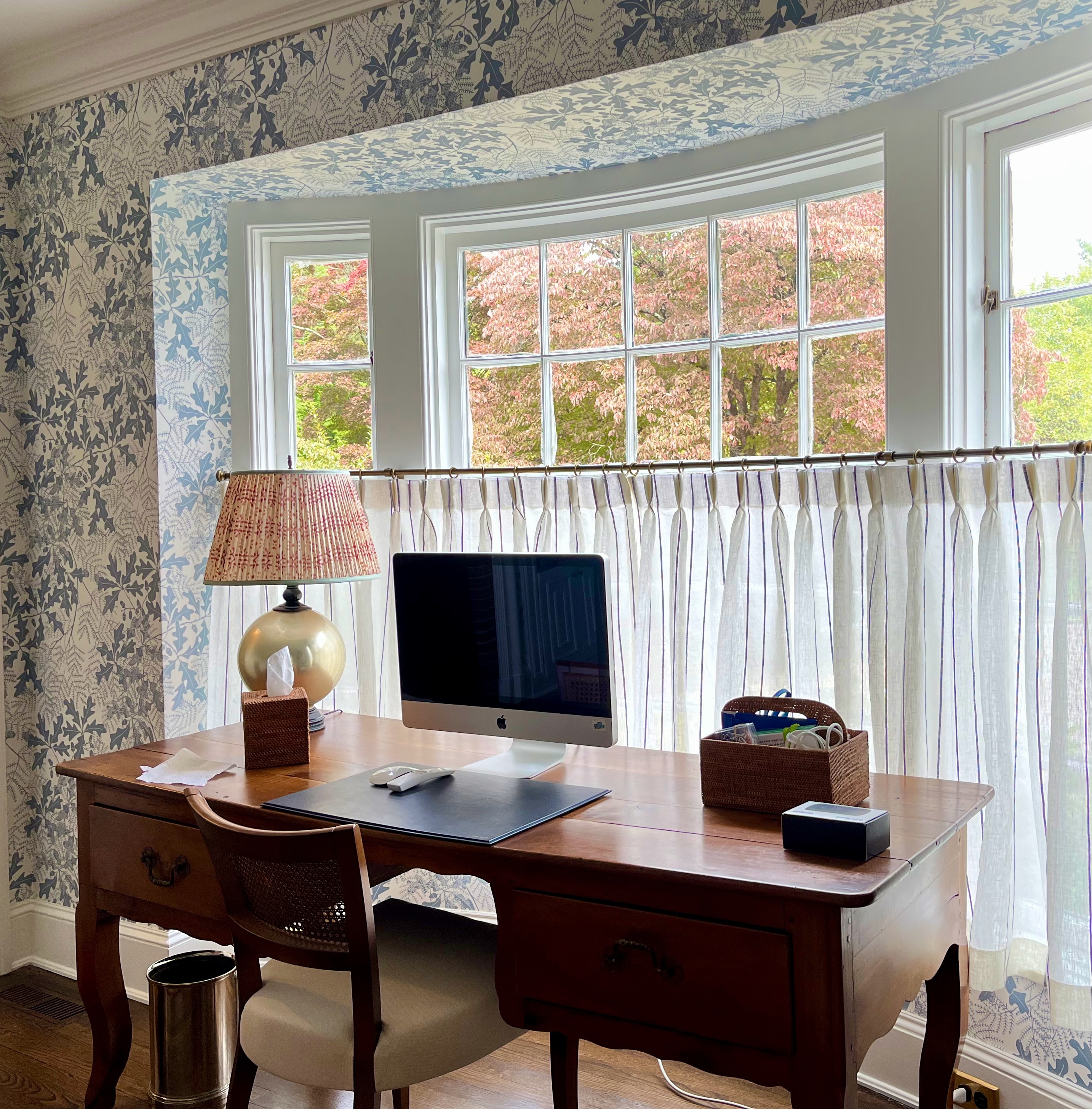 Linen cafe curtains on brass rod in home office with botanical wallpaper