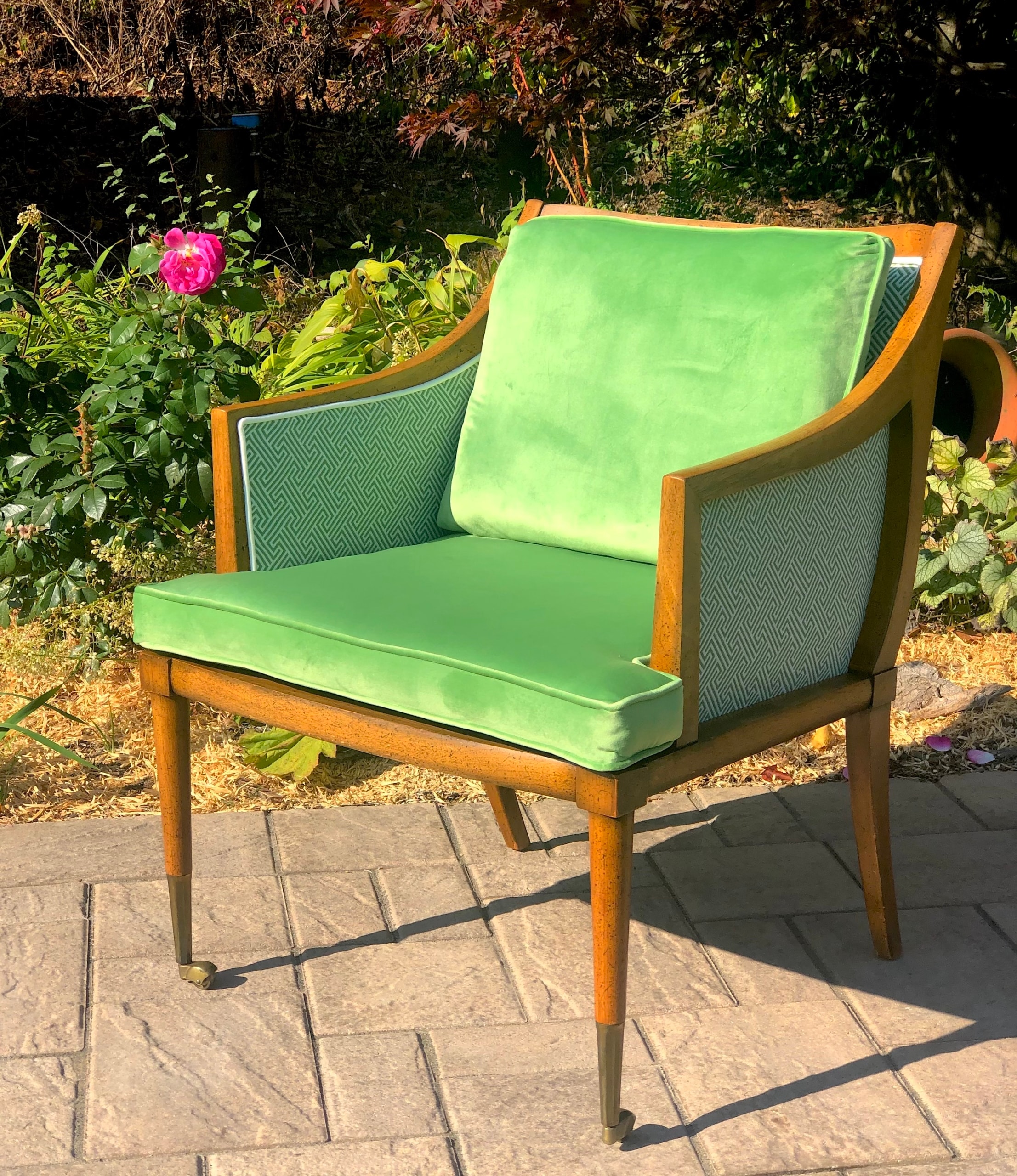 Mid-century modern chair with green cushions in garden