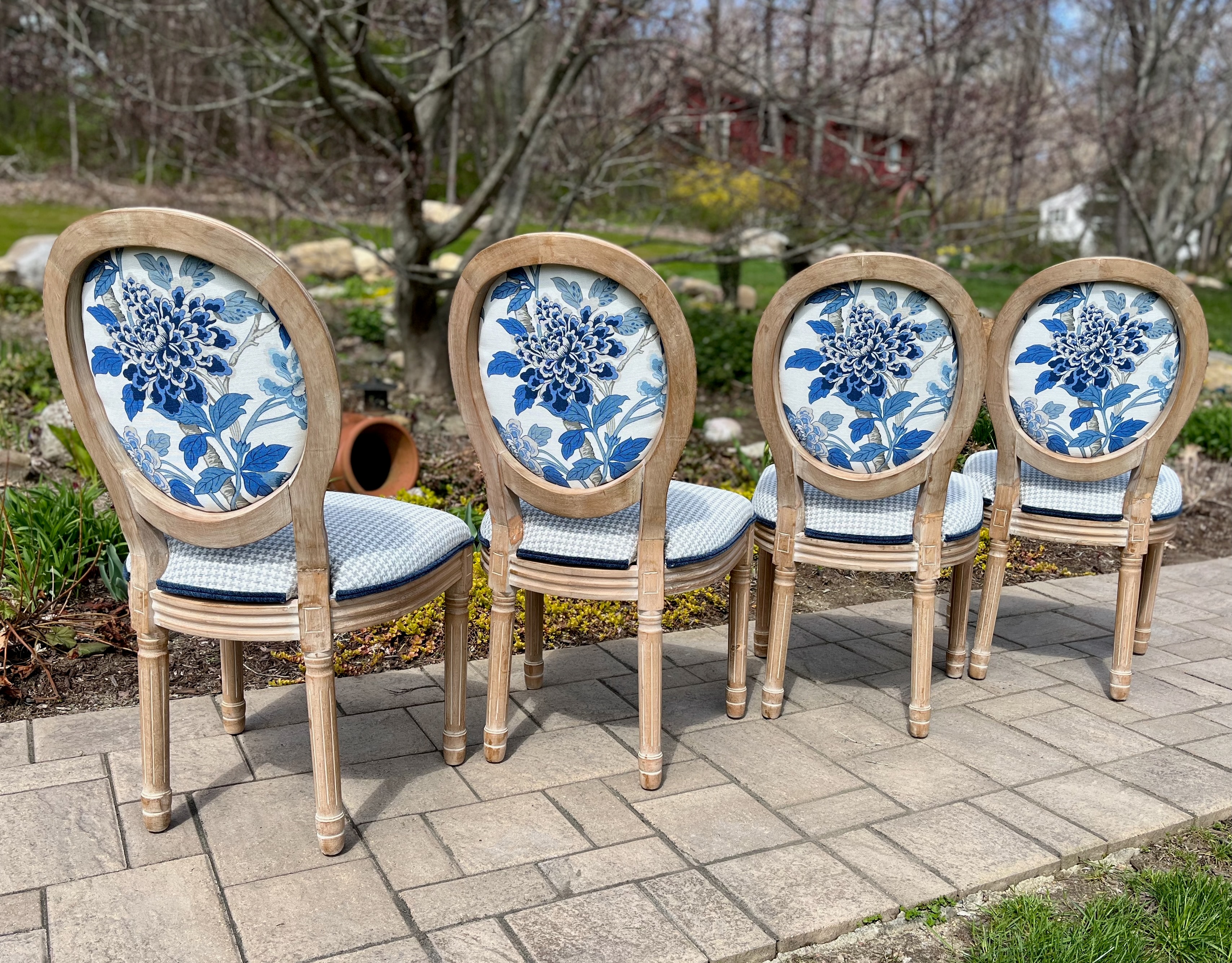 Four wooden chairs with blue floral upholstery